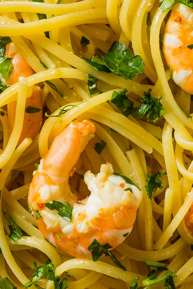 a closeup of instant pot shrimp scampi over pasta